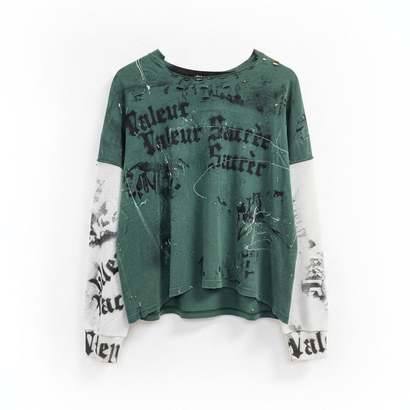 Green and white distressed sweatshirt with text on a hanger in a store setting.